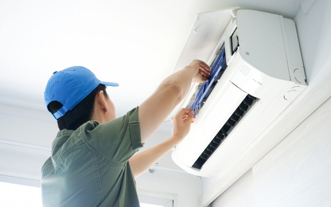 HVAC technician servicing a ductless mini split in Claremont